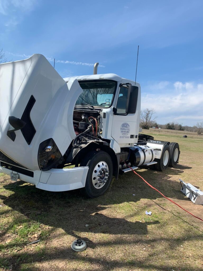 Semi truck with hood open for engine repair in East Texas