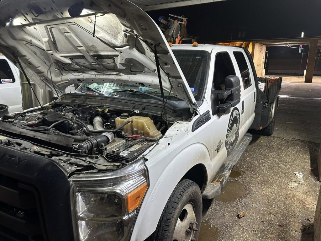 Truck engine repair under hood by mobile mechanic in East Texas