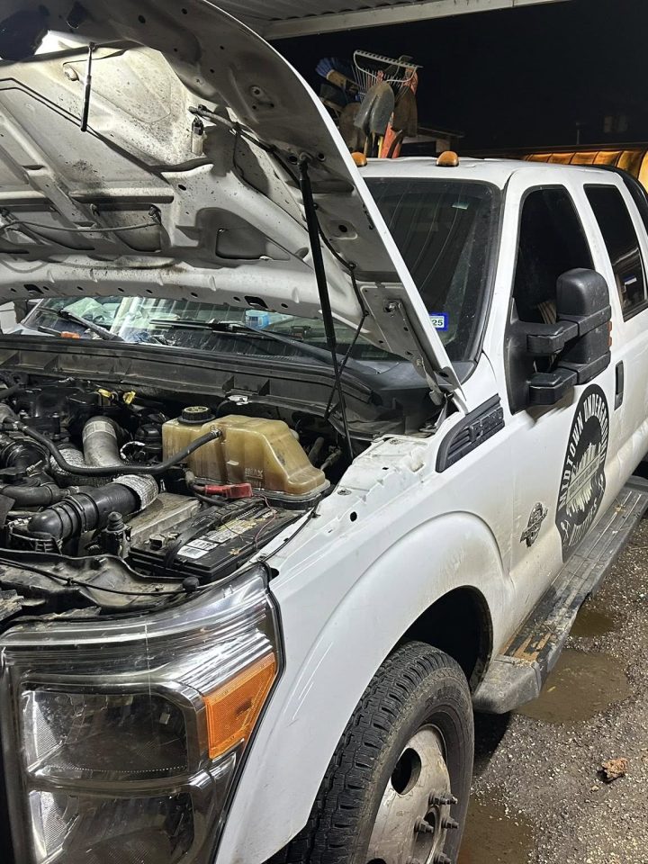 Truck engine repair under hood by mobile mechanic in East Texas